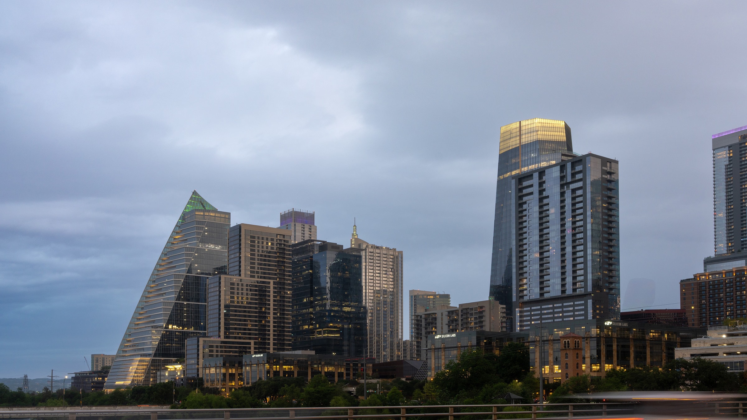 Stunning view of Austin's skyline at dusk with modern skyscrapers under a dramatic sky.